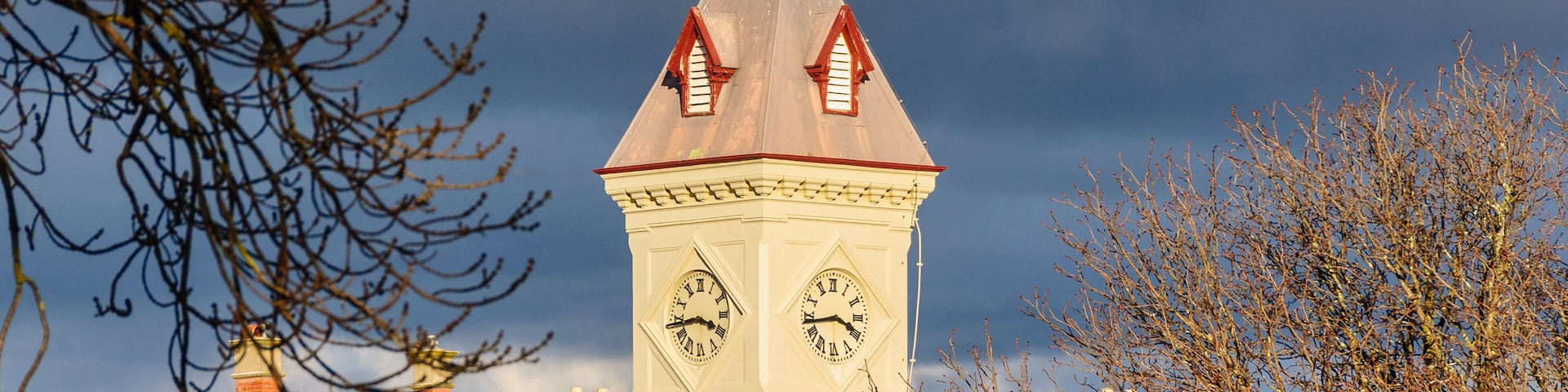 The clock tower of the Post Office lit by bright afternoon autumn sunshine - Kyneton, Victoria, Australia