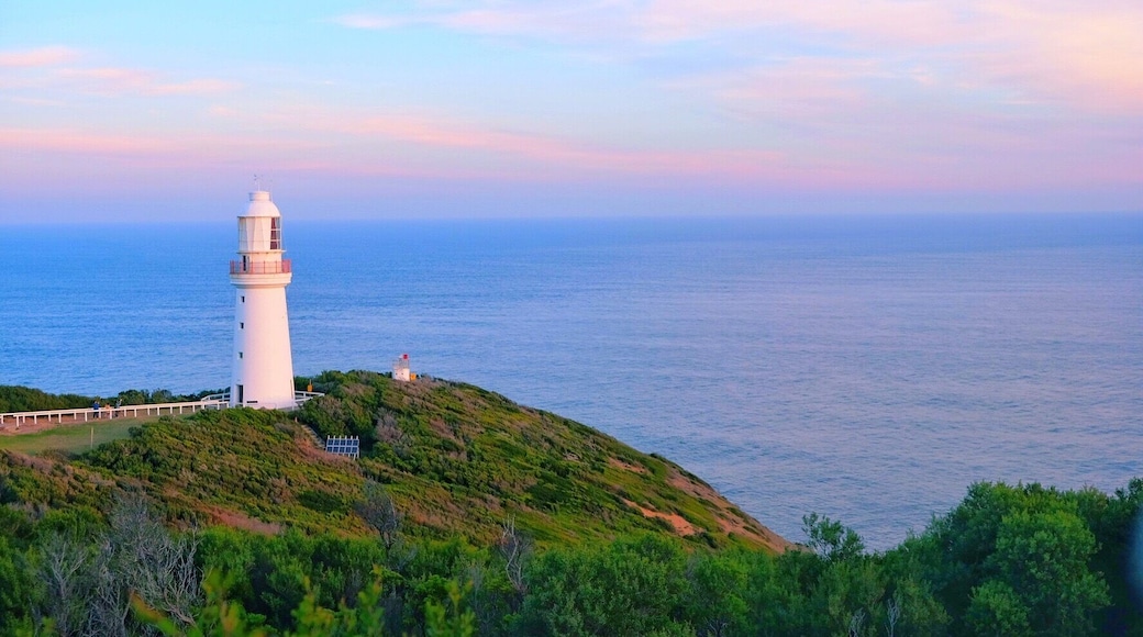 Lighthouse under setting sun.