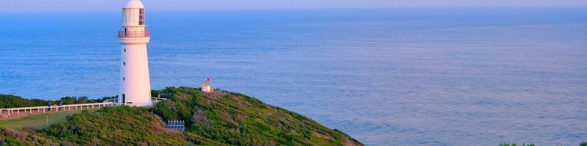 Lighthouse under setting sun.