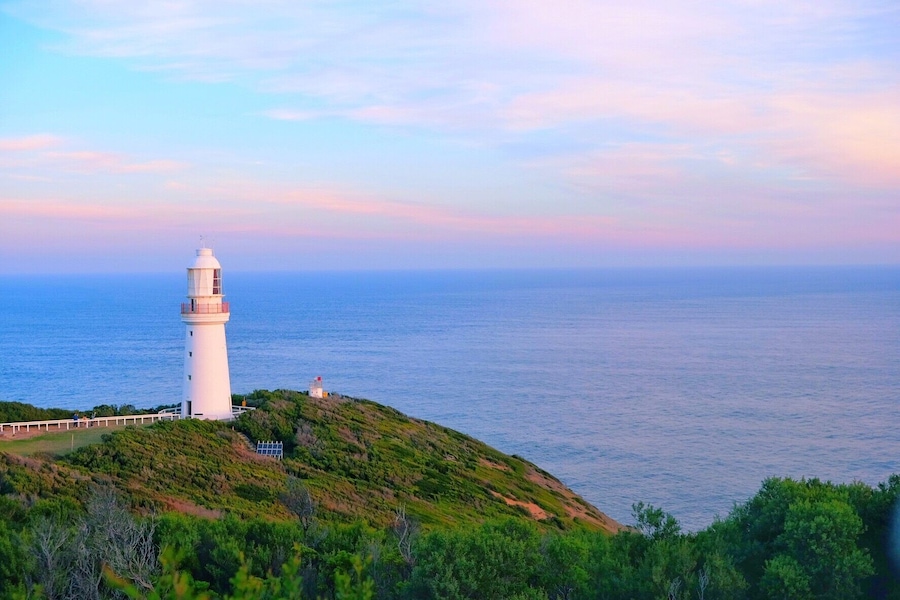 Lighthouse under setting sun.