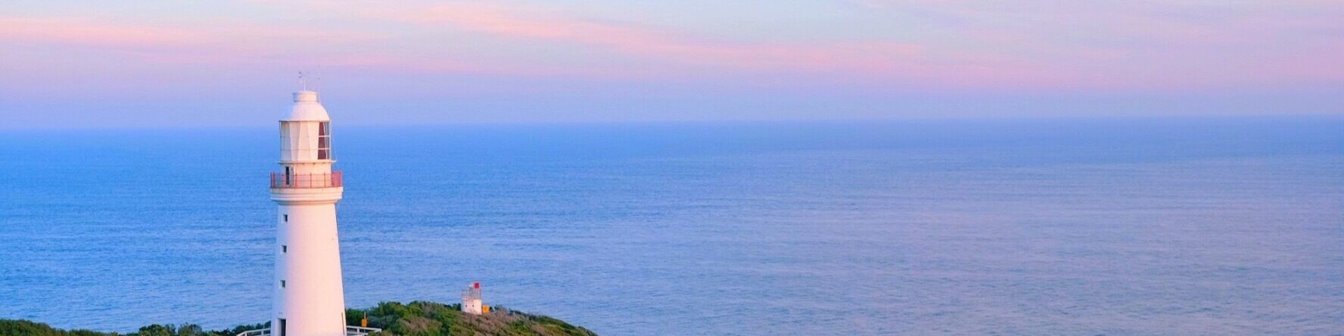 Lighthouse under setting sun.