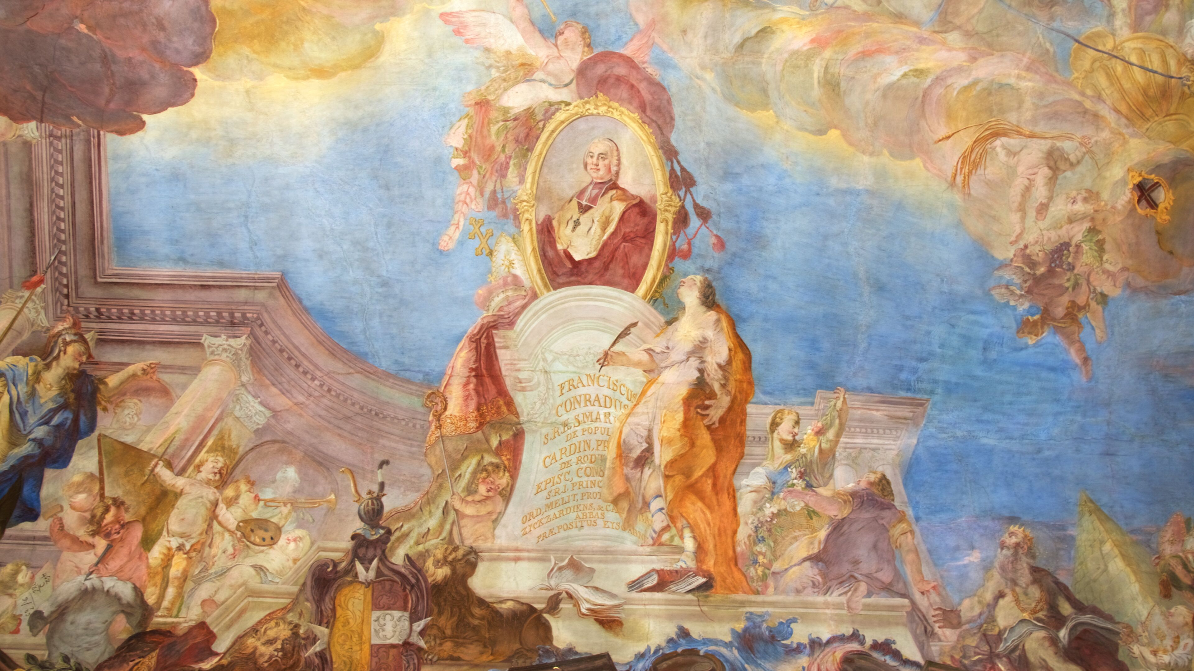 A fresco mural with a central figure on a pedestal, surrounded by cherubs and classical architectural elements.