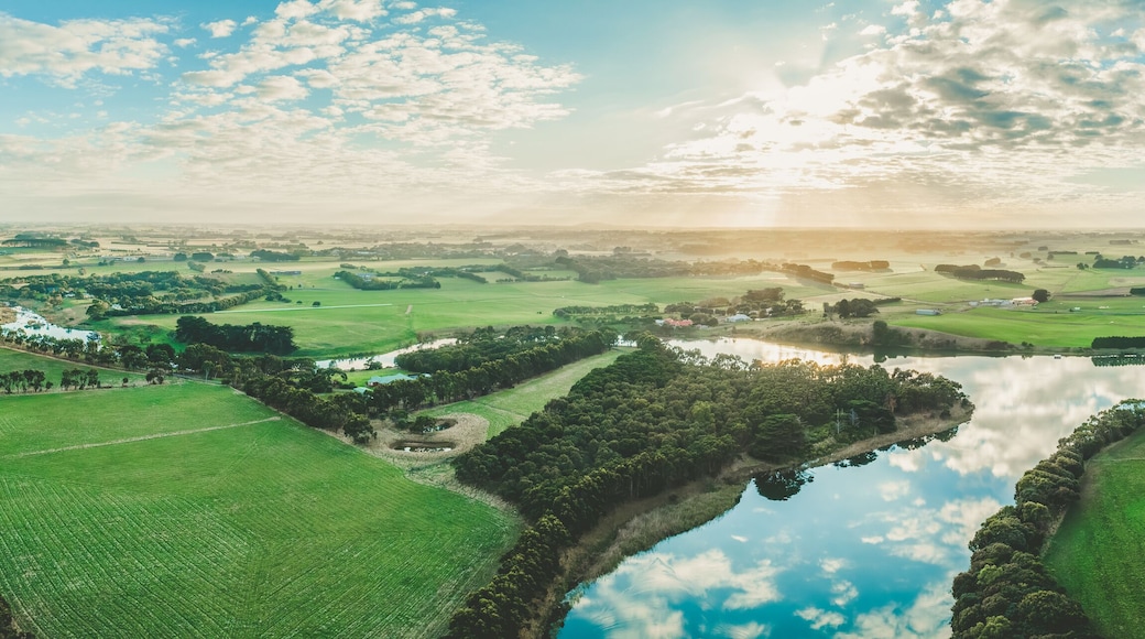 Wide aerial panorama of sunset over Hopkins River and grasslands in Warrnambool, Australia
