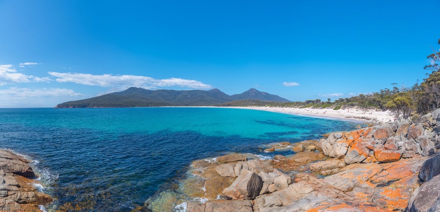 People are enjoying a sunny day at Wineglass bay in Tasmania, Australia