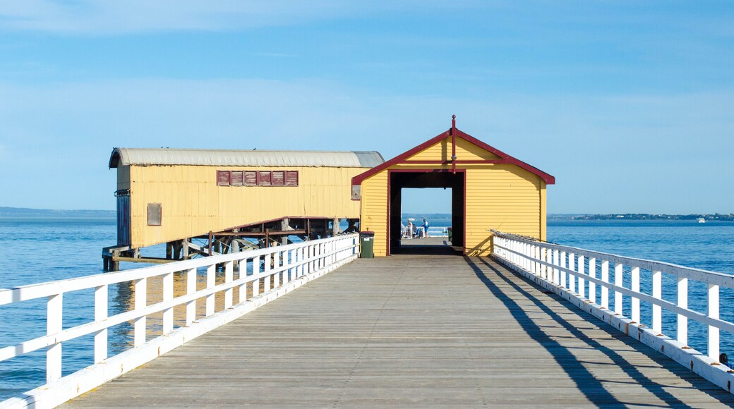 The historic building of Queenscliff South Pier against the blue ocean on a sunny day. Victoria, Australia. The pier is a prominent tourist attraction and recreational fishing area in the coastal town