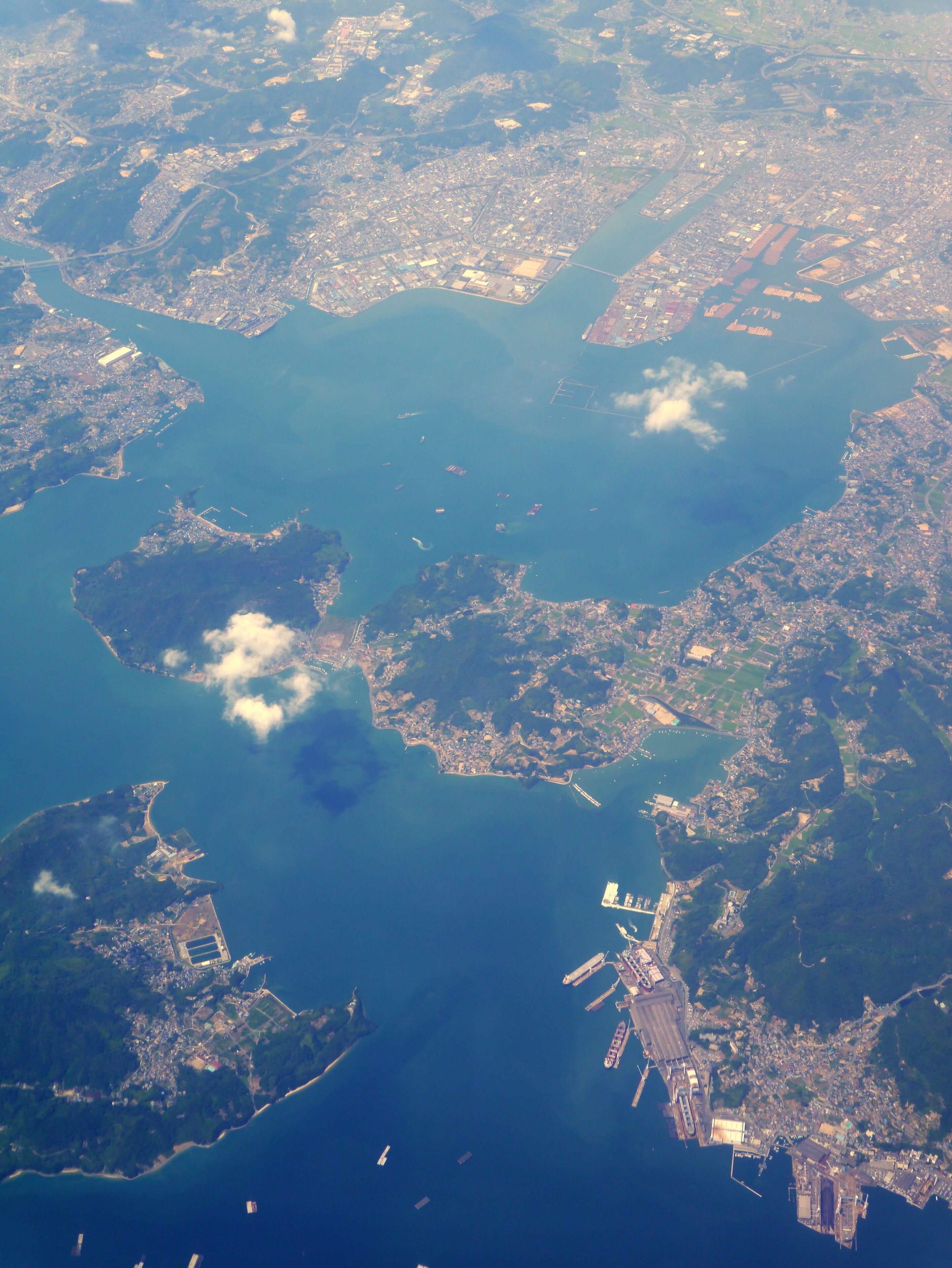 An aerial view of a coastal city with several islands and a large body of water.