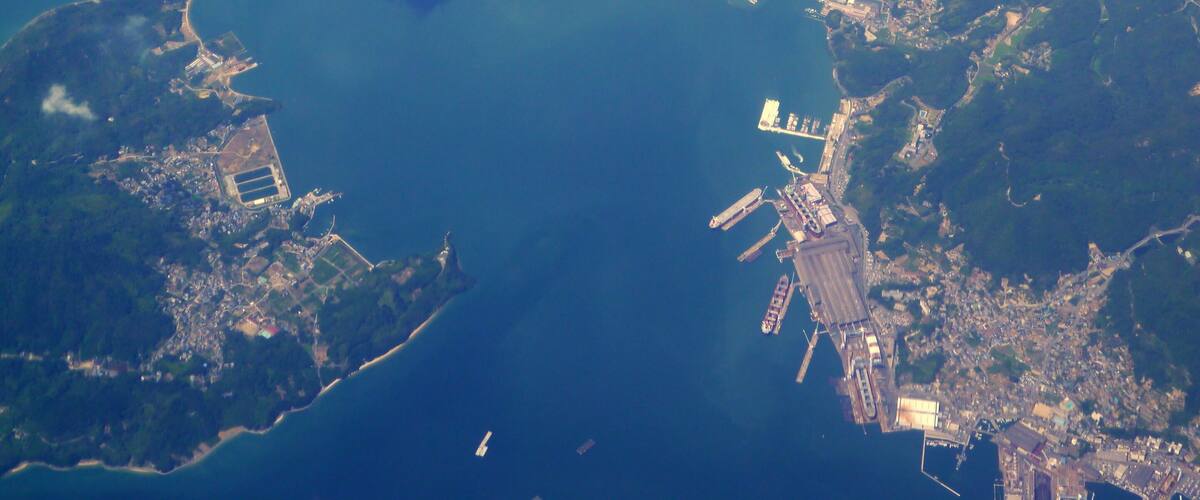 An aerial view of a coastal city with several islands and a large body of water.