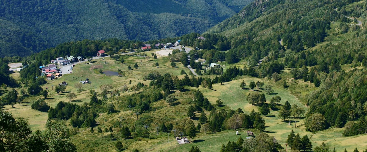 A mountainous landscape with a small town nestled in a valley.