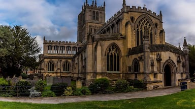 A historic church with Gothic architecture, featuring pointed arches and a large rose window.