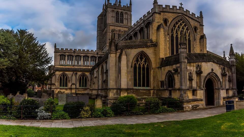 A historic church with Gothic architecture, featuring pointed arches and a large rose window.