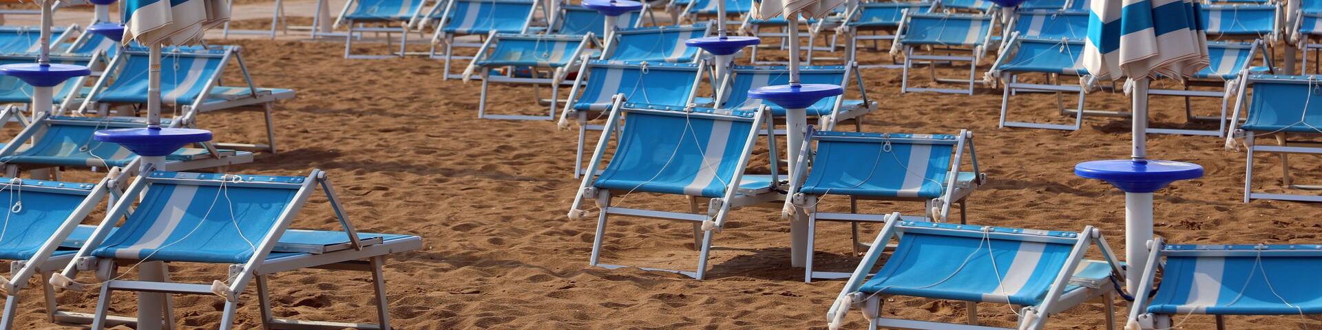 many umbrellas and deck chairs