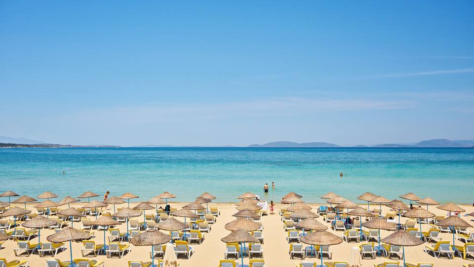 Empty sunbeds on ilica beach by the open sea, Cesme