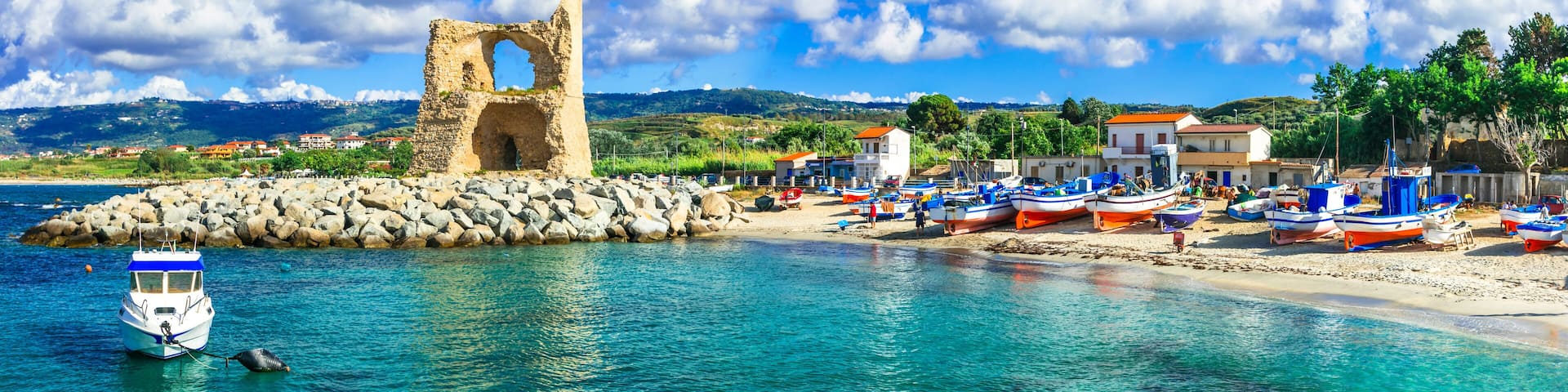 High resolution panorama of Briatico and the ancient Saracen tower (Torre della Rocchetta) on the beach. Turquoise sea and traditional fishing village in Calabria, Italy.