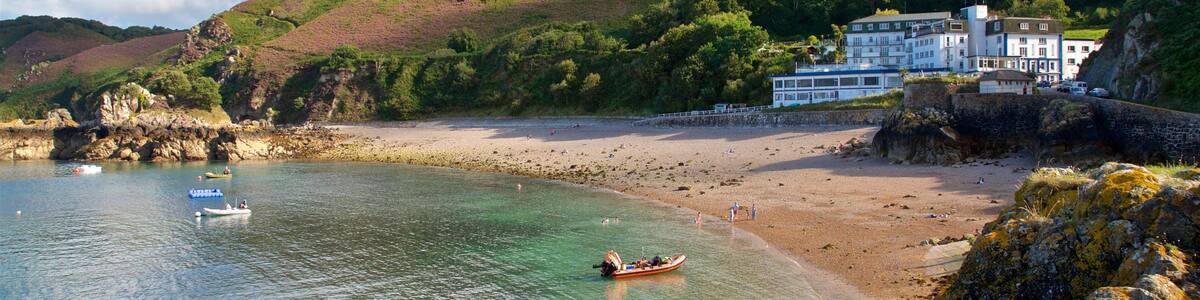 Bouley Bay featuring a house, rugged coastline and a sandy beach