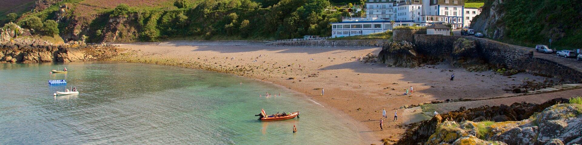 Bouley Bay which includes a beach, general coastal views and rocky coastline
