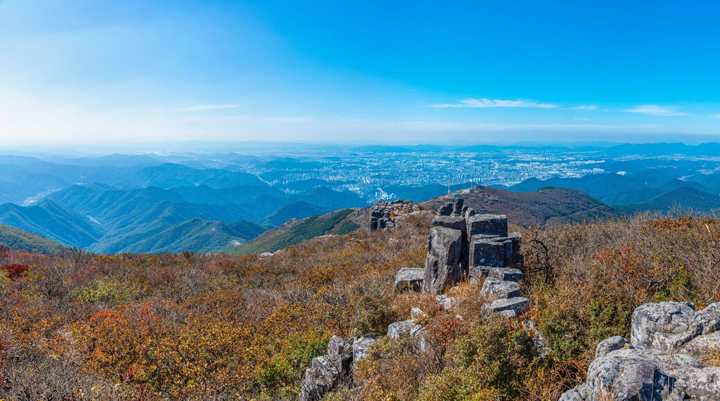 Gwangju viewed behind rocks of Jusangjeolli Cliff at Mudeungsan Mountain, Republic of Korea
