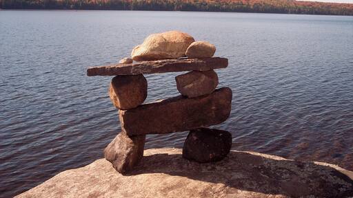 Look beyond the recently constructed inukshuk to the glorious colours of Algonquin in Autumn. #lakes $forests #troveon #colorful
