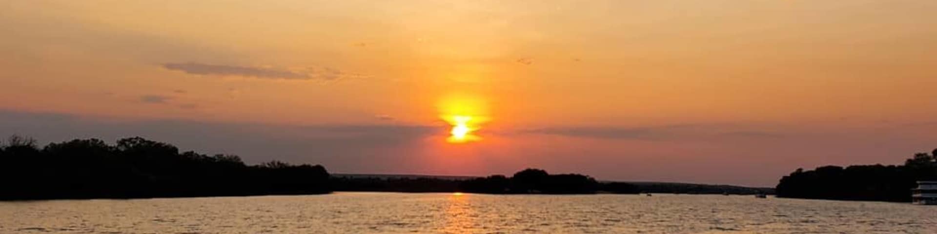 Cruise along the Zambezi River which flows in between Zambia and Zimbabwe