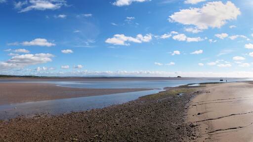 panoramic view of the beach at canal foot in ulverston with a view of the beach a river leven with morecambe bay in the distance