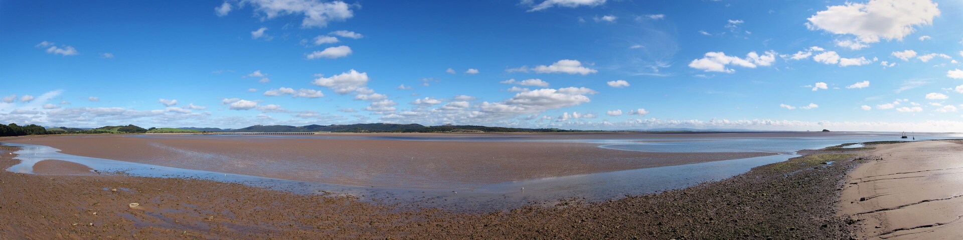 panoramic view of the beach at canal foot in ulverston with a view of the beach a river leven with morecambe bay in the distance