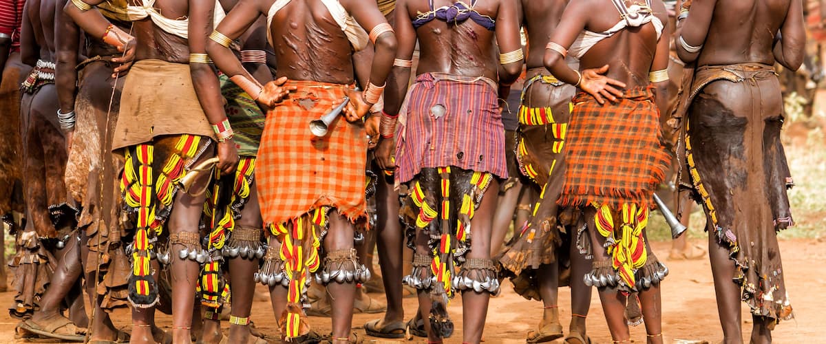 A group of people in traditional attire standing in a line.