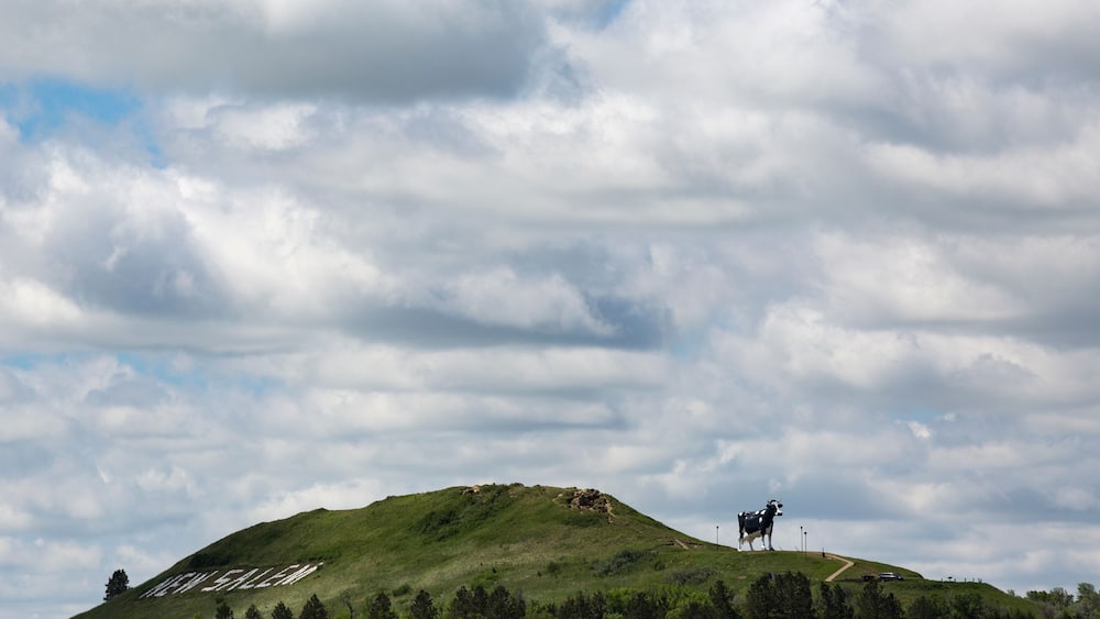 View of Salem Sue on hill against cloudy sky
