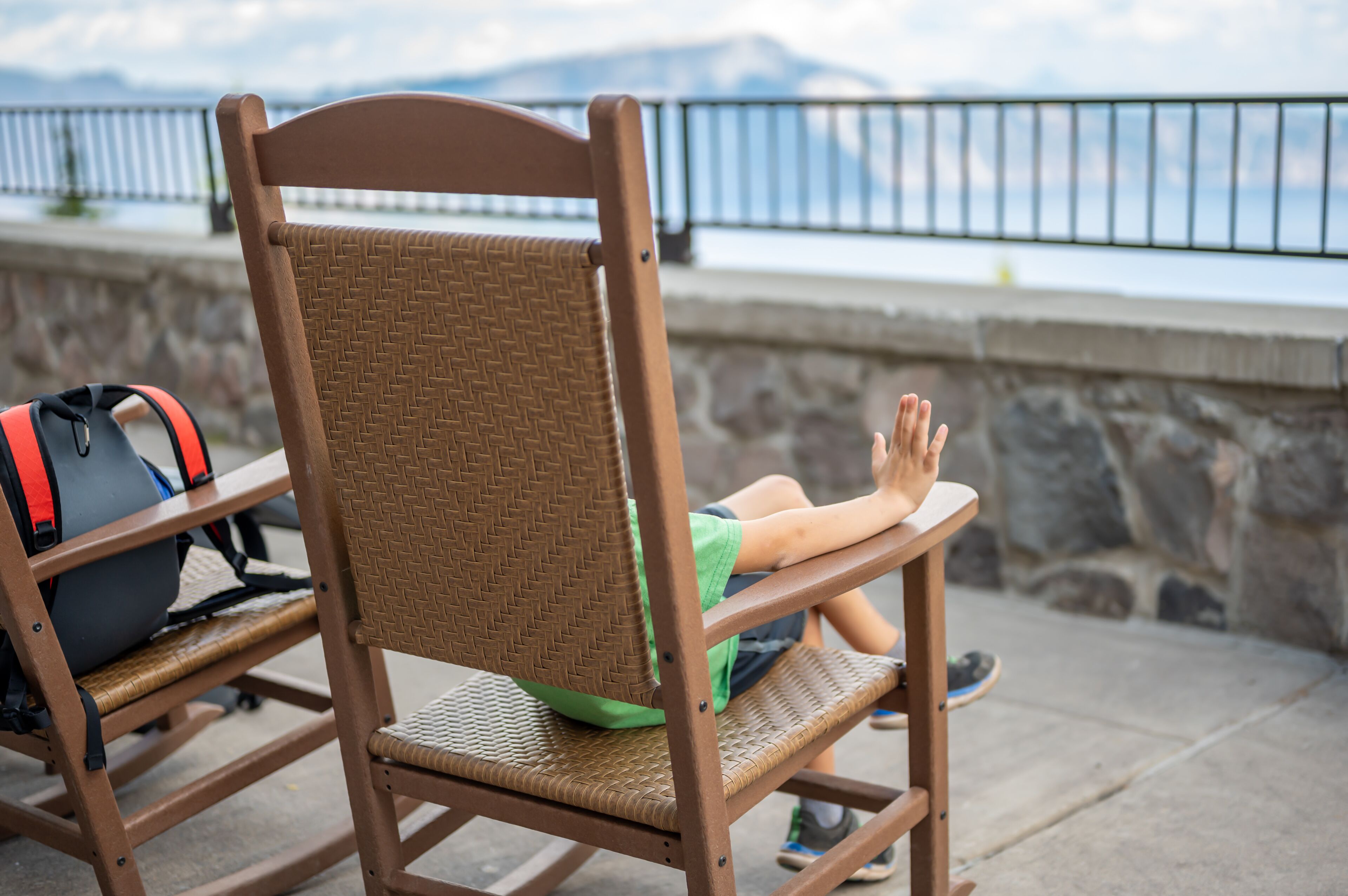 rocking chairs on the outdoor walkway of the lodge overlooking Crater Lake National Park