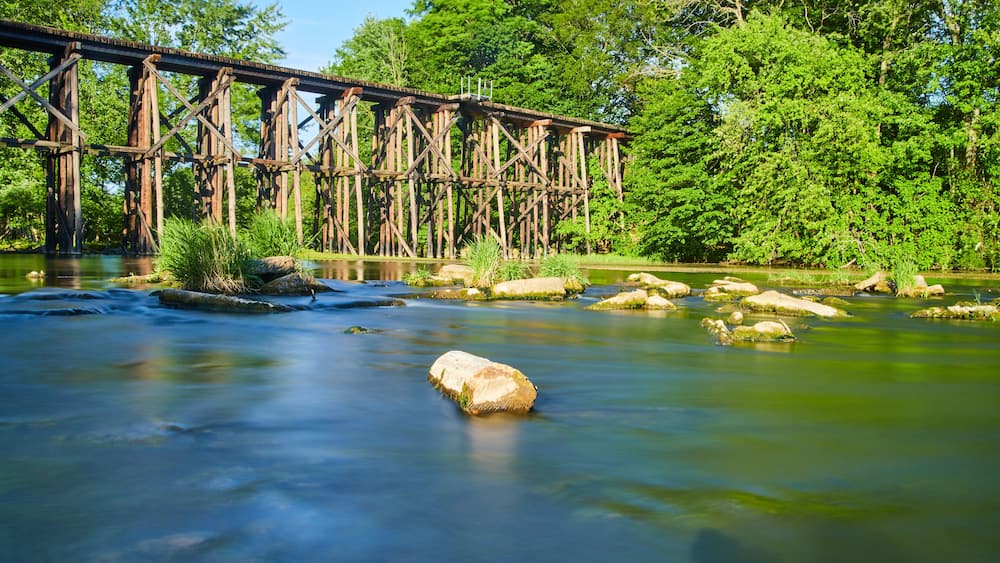 Old wooden railroad bridge over water