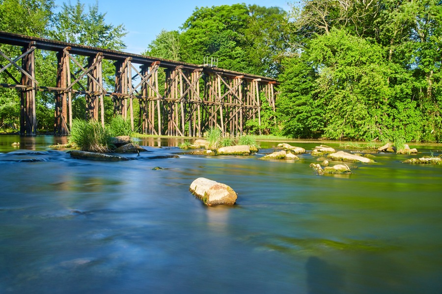 Old wooden railroad bridge over water