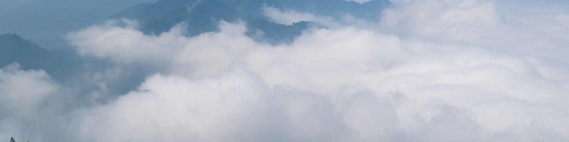 A mountain range with clouds below.