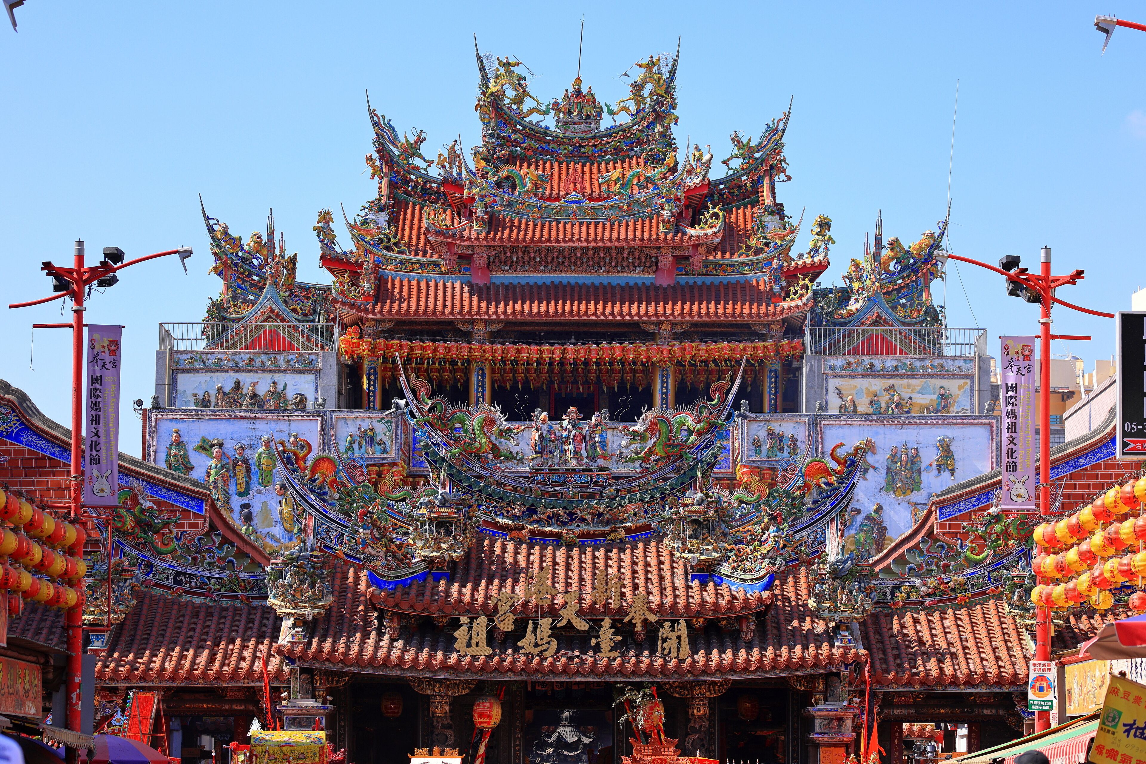 A traditional multi-tiered temple with ornate decorations and colorful dragons.