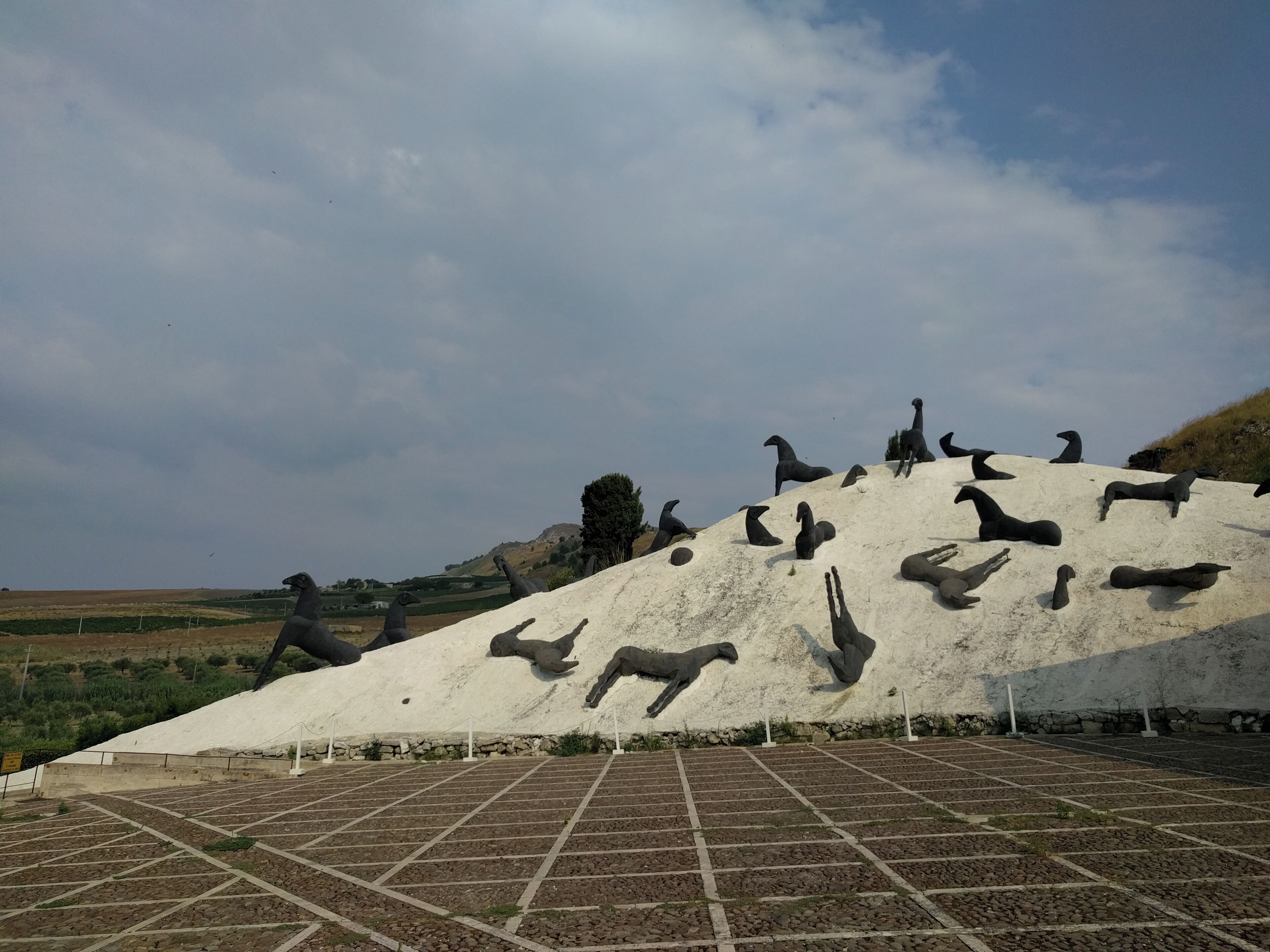 A large sculpture of animals on a hill.