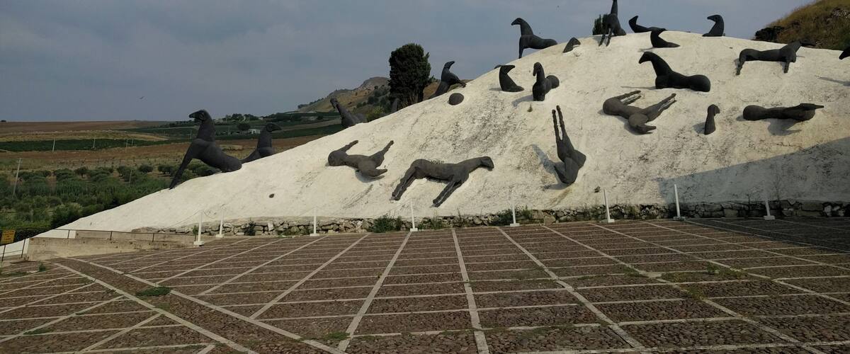 A large sculpture of animals on a hill.