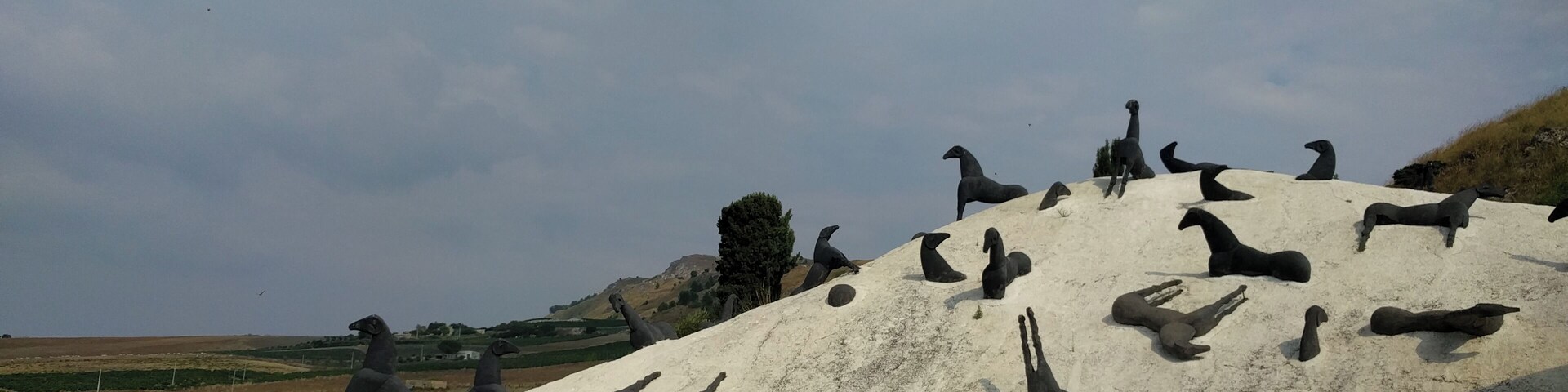A large sculpture of animals on a hill.