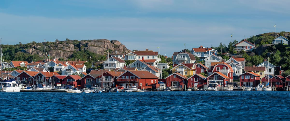 A coastal village with colorful houses and boats docked at the harbor.