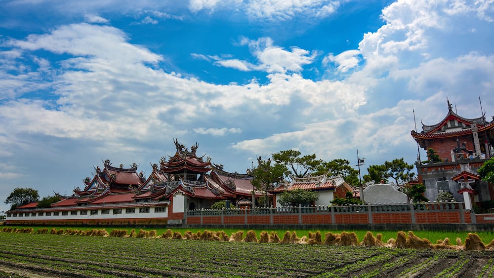Newly planted farmland and Chinese style rooftops of the old Huwei Chifa Matsu Temple in Yunlin County, Taiwan, Shutterstock ID 557811451, SF SSA Case with Manager Approval: Case 07151371, Job: Prepay