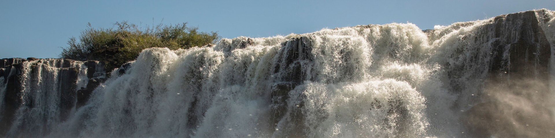 Travel and explore. Navigating the river. View of the Mocona falls from the boat in a summer sunny day.
