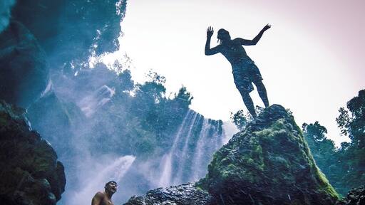 Jumping into one of the pools that form under the Pulahpanzak waterfall.