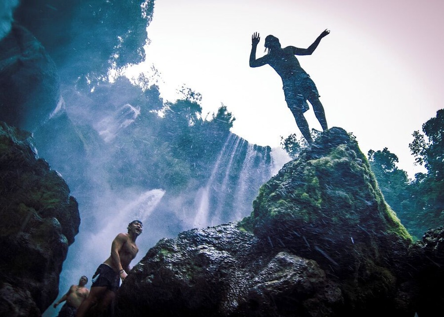 Jumping into one of the pools that form under the Pulahpanzak waterfall.