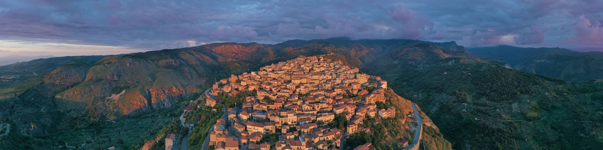 180 degree virtual reality panorama of a small village type perched on the mountains facing the sea during sunset over Nebrodi, Sicily, Italy.