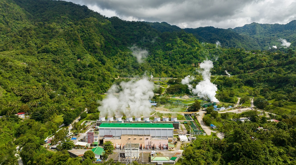 Aerial view of geotermal power plant in the mountains. Geothermal station with steam and pipes. Negros, Philippines.