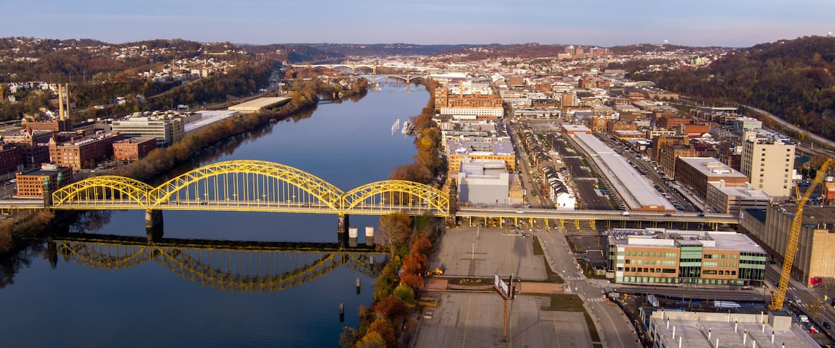 Aerial view of Pittsburgh, Pennsylvania's Strip District (right). The David McCullough 16th Street Bridge crosses the Allegheny River from Troy Hill (left).