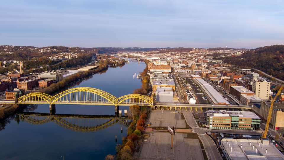 Aerial view of Pittsburgh, Pennsylvania's Strip District (right). The David McCullough 16th Street Bridge crosses the Allegheny River from Troy Hill (left).