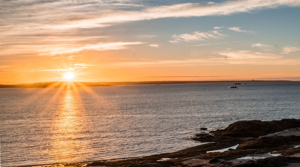 sunrise over the Bay of Fundy near Pocologan and New River Beach in New Brunswick with small tidal pools in the foreground