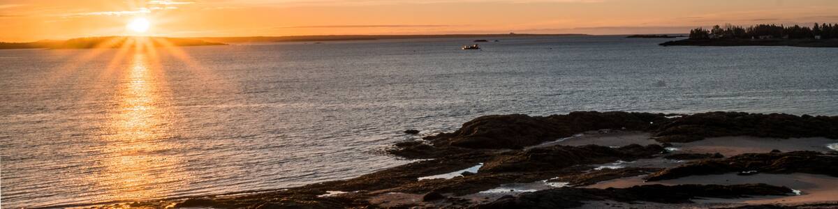 sunrise over the Bay of Fundy near Pocologan and New River Beach in New Brunswick with small tidal pools in the foreground