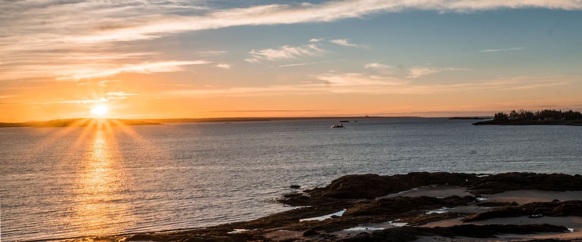 sunrise over the Bay of Fundy near Pocologan and New River Beach in New Brunswick with small tidal pools in the foreground