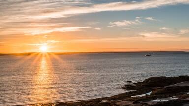 sunrise over the Bay of Fundy near Pocologan and New River Beach in New Brunswick with small tidal pools in the foreground