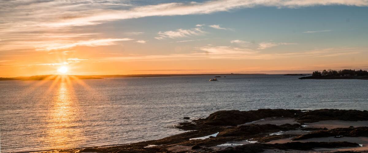 sunrise over the Bay of Fundy near Pocologan and New River Beach in New Brunswick with small tidal pools in the foreground