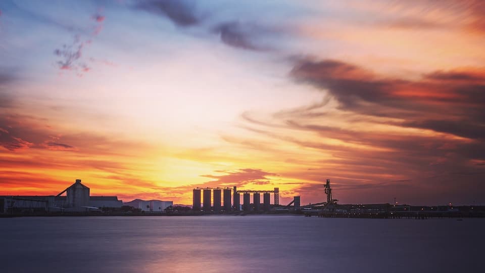 Out on the southern break wall over looking the sugar stacks as the sun sets.