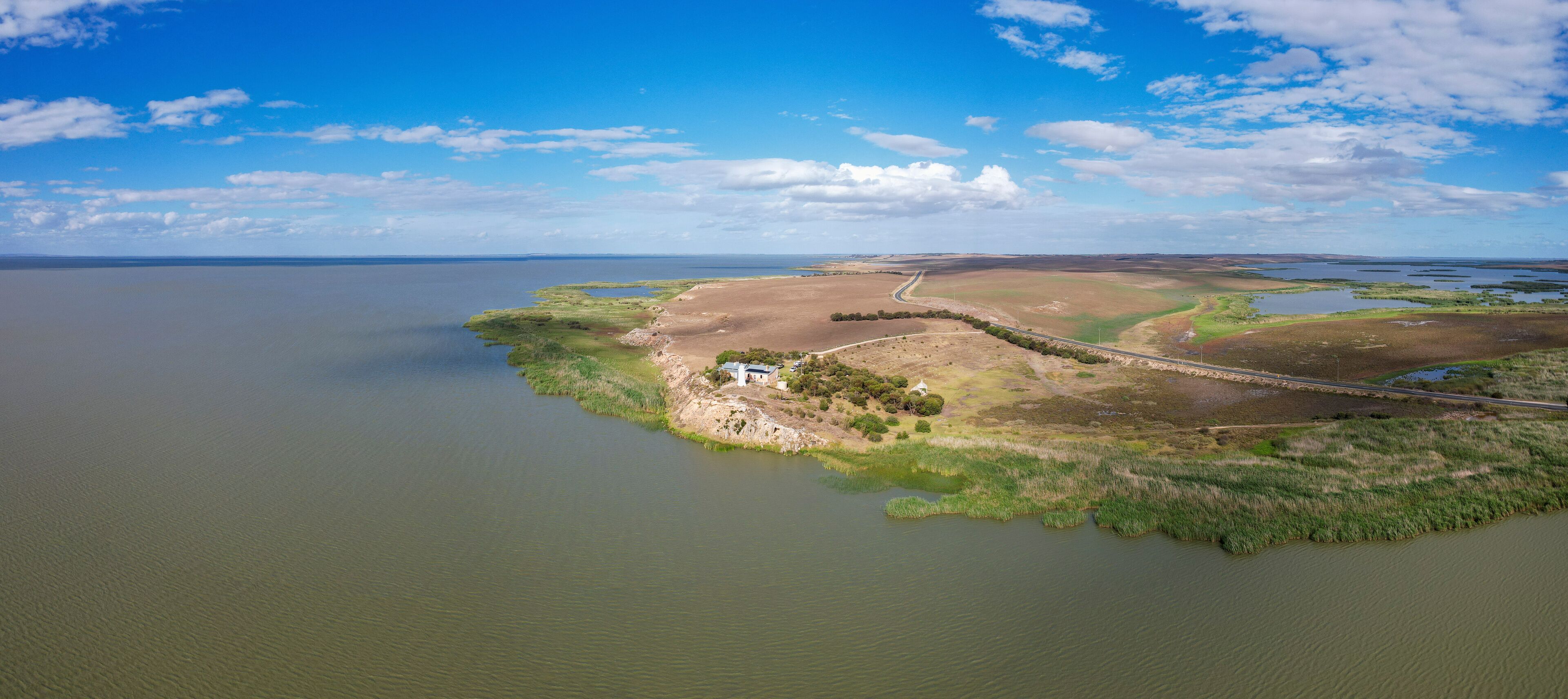 Aerial view of Point Malcom Lighthouse and Lake Alexandrina in a tranquil landscape, Meningie, South Australia, Australia.
